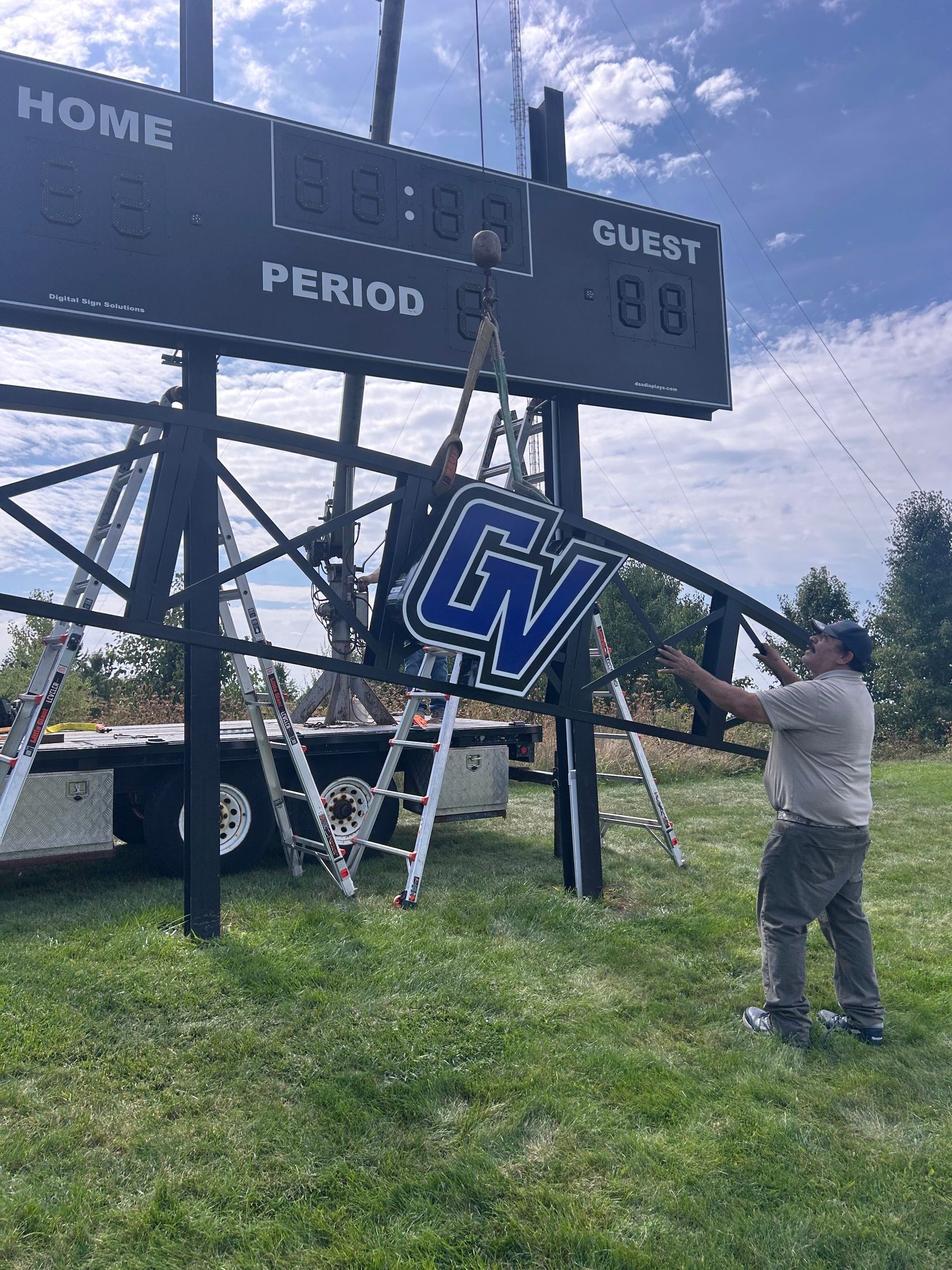 Digital Sign Solutions team installing the GVSU scoreboard logo structure