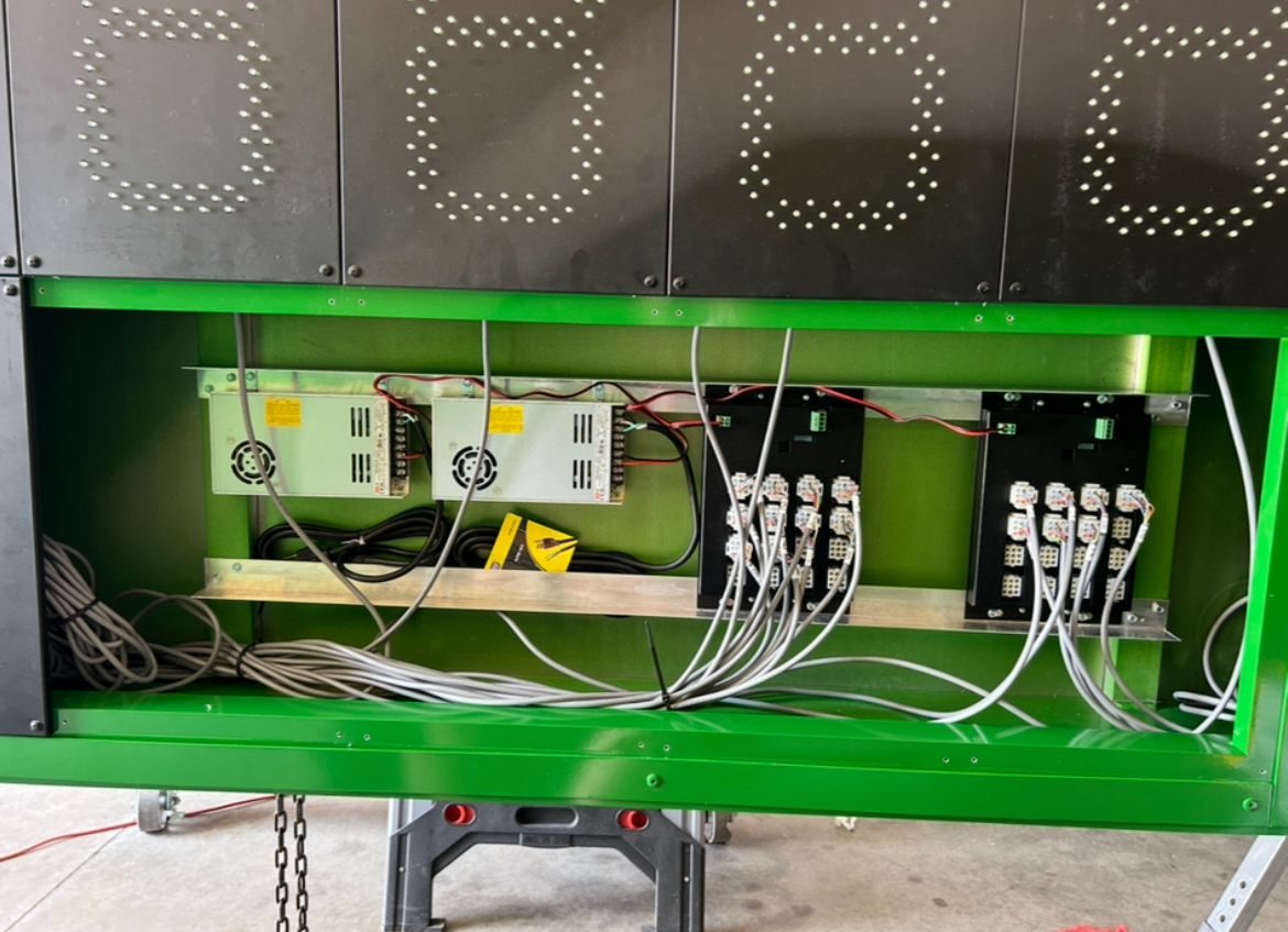 Service-friendly wiring and power components inside a fixed digit scoreboard
